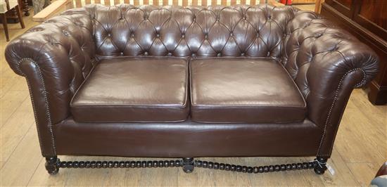 A buttoned brown leather buttonback two seater chesterfield settee W.approx. 175cm